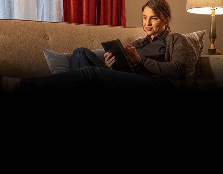 woman on couch with tablet